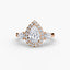 Rose gold diamond ring with a pear-shaped center stone and side stone on a white background