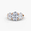 Three-stone diamond ring with rose gold setting on a white background