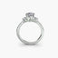 White gold ring with a three diamond and side u pave on a white background