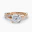 Rose gold ring with a large Asscher cut diamond and smaller diamonds on the twisted band against a white background