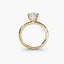 Side view of The Seris showing cushion cut diamond in secure double prong setting yellow gold