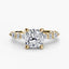 Gold ring with a large cushion cut diamond and smaller marquise shaped and round cut diamonds on the band against a white background