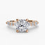 Rose gold ring with a large cushion cut diamond and smaller marquise shaped and round cut diamonds on the band against a white background