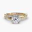 Gold ring with a large cushion-cut diamond and smaller diamonds on the twisted band against a white background
