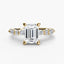 Gold ring with a large emerald-cut diamond and smaller diamonds on the sides against a white background