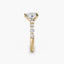 Gold ring with a heart shaped diamond and smaller round diamonds on a white background