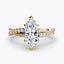 Gold ring with a marquise-shaped diamond twisted pave band on a white background