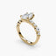 Gold ring with a marquise shaped diamond on a white background