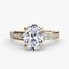Gold ring with a large oval diamond and smaller round diamonds on the band against a white background