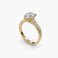 Gold ring with a pear-shaped diamond and pave on the shank on a white background