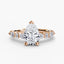 Rose gold ring with pear-shaped diamond on a white background