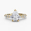 Pear shaped diamond ring with marquise and round side stones yellow gold on a white background