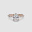 Rose gold ring with a large oval diamond and smaller marquise and round diamonds on the sides against a white background