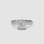 Gold ring with a large central princess diamond and smaller diamonds on the band against a white background