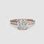 Rose gold ring with a large round diamond and smaller diamonds on the band against a white background