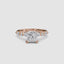 Rose Gold ring with a large central princess diamond and smaller diamonds on the band against a white background