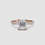 Rose gold ring with a large emerald-cut diamond and smaller diamonds on the sides against a white background