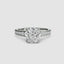 White gold ring with a large round diamond and smaller diamonds on the band against a white background