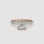 Gold ring with a large cushion cut diamond and smaller marquise shaped and round cut diamonds on the band against a white background