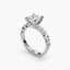 Diamond ring with a central princess-cut diamond and smaller diamonds on a white background