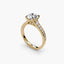 Gold ring with a center round diamond and pave side stones on a white background