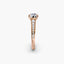 Rose gold ring with diamonds on a white background