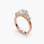 Rose gold ring with three diamonds on a white background