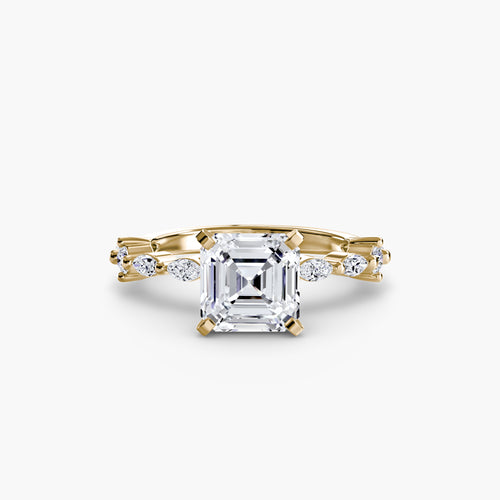 Gold ring with a large Asscher diamond and smaller diamonds on a white background