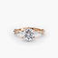 Rose gold ring with a large round diamond and smaller diamonds on the side of the shank on a white background