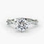 Round diamond ring with side stone in white gold on a white background