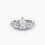 Three stone ring pear shaped diamond round side and micro pave shank white gold on a white background