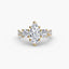 Three stone marquise shaped diamond ring with round diamonds on the side and u micro pave setting on twisted shank yellow gold on white background
