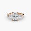 Rose gold ring with a large radiant cut center diamond and smaller diamonds on the sides against a white background