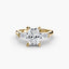 Gold ring with a large radiant diamond and smaller baguetts diamonds on the sides against a white background