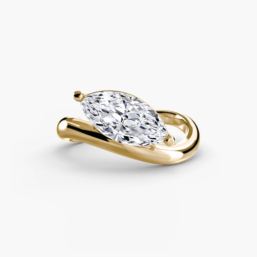 Gold curved ring with a marquise-shaped diamond on a white background