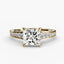 Gold ring with a large princess cut diamond and smaller pave diamonds on the band against a white background