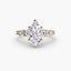 Gold ring with a marquise-shaped diamond on a white background