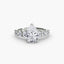 Diamond ring with a pear-shaped center stone on a white background