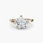 Gold ring with a pear-shaped diamond and baguette side stones on a white background