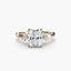 Gold ring with a large radiant cut diamond and smaller diamonds on the sides against a white background