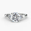 Round diamond ring with side baguette stone white gold on a white background