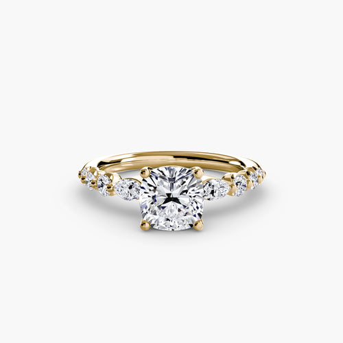 Gold ring with a cushion diamond on a white background