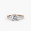 Rose gold ring with a large round brilliant diamond and smaller diamonds on the band against a white background