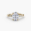 Gold ring with a large oval diamond and smaller diamonds on the band against a white background