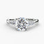 Round diamond solitaire ring with a two side round diamonds white gold platinum on a white background