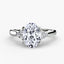 Solitaire oval diamond ring with three round diamond on the side white gold on a white background.