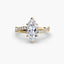Twisted engagement ring with a marquise cut diamond and micro pave setting on the shank yellow gold on the white background