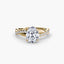 Gold ring with a large diamond and smaller diamonds on the band against a white background