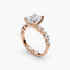 Rose gold ring with a large diamond and smaller stones on a white background
