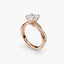 Rose gold ring with a large Asscher cut diamond and smaller diamonds on the band against a white background